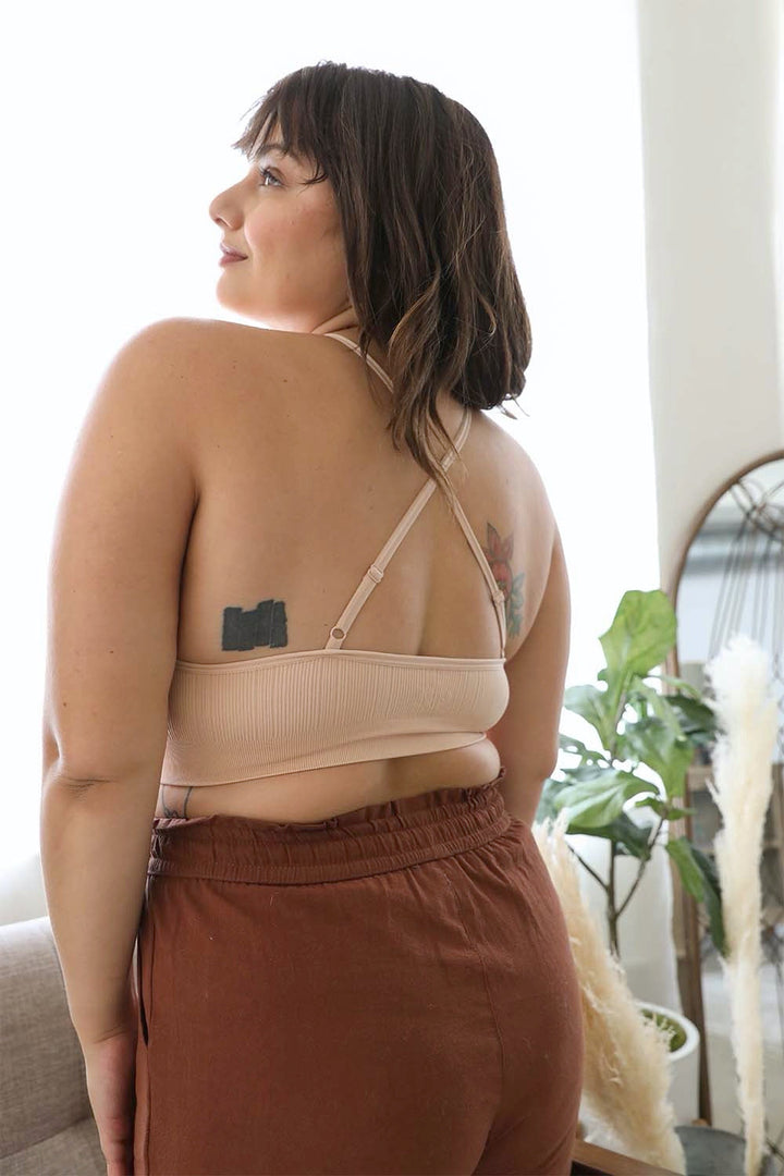 High neck crochet blush bralette with decorative cross-back straps.